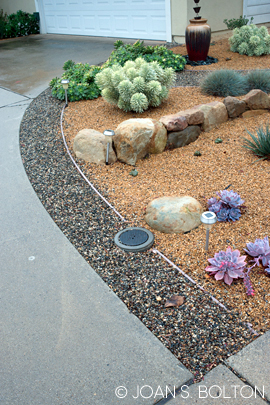 An 18"-wide band of gravel, plus a beefy strip of recycled plastic benderboard, are all it took to widen this driveway.